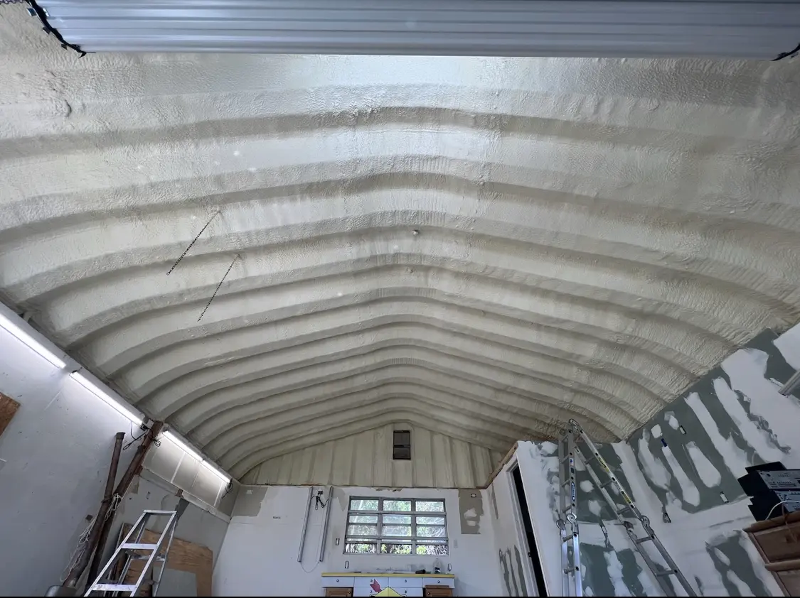 Spray polyurethane foam applied to the underside of a metal roof deck in Palm City